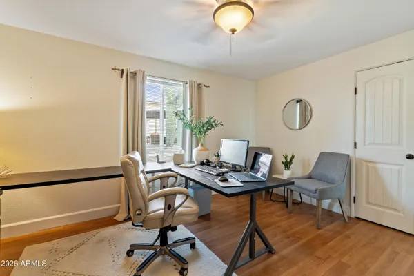 a kitchen with stainless steel appliances granite countertop a refrigerator a stove and white cabinets with wooden floor