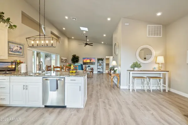 a bathroom with a granite countertop sink and a toilet