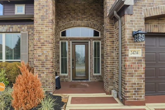 24714 Longwood Forest Drive Spring, TX 77373 - Photo 3 of 21 This welcoming home features a classic brick exterior with a stylish front entryway, complete with sidelights and an arched transom window. The neat landscaping and elegant lighting add charm and curb appeal.