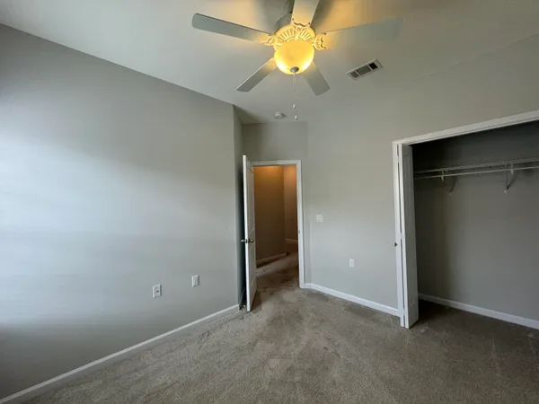 an empty room with a empty space and a ceiling fan
