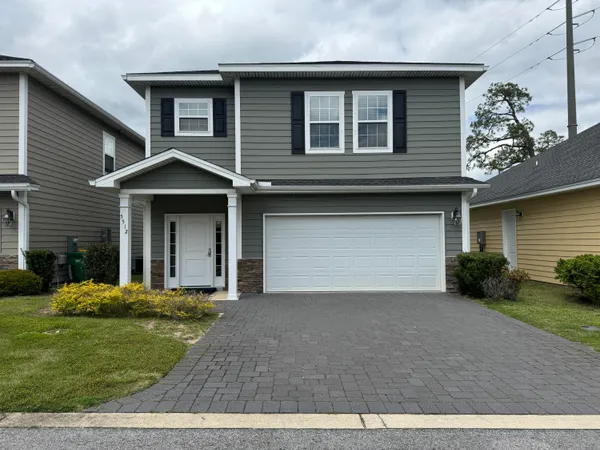 a front view of a house with a yard and garage