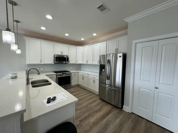 a kitchen with granite countertop stainless steel appliances and wooden cabinets