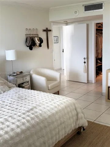 a bedroom with a bed and a lamp on table