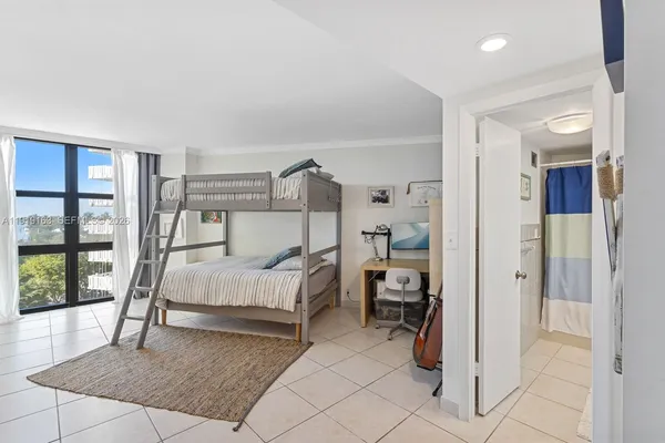 a bed room with a bed and a large window