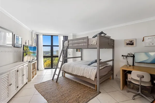a bedroom with a bed and a view of walk in closet