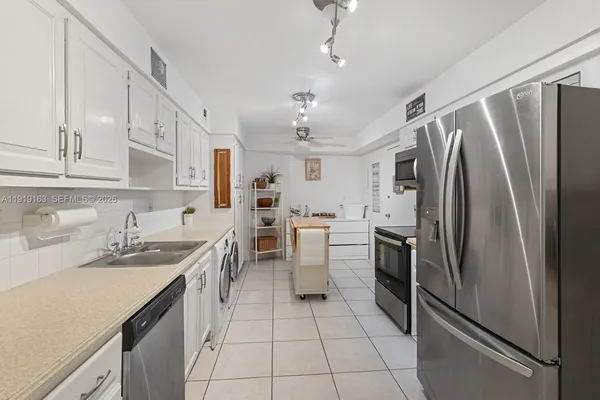 a kitchen with a sink appliances and cabinets
