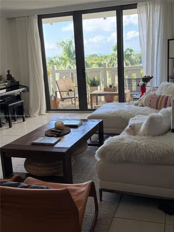 a living room with furniture and large windows