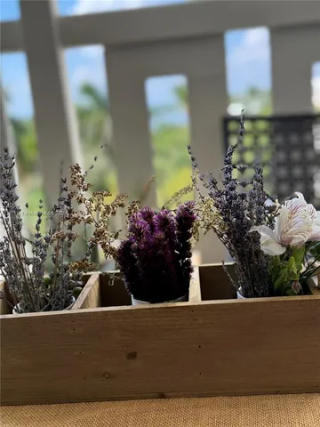 a front view of a house with a yard chairs and table