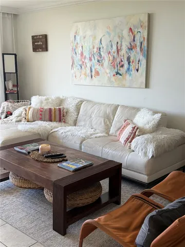 a living room with furniture and wall painting