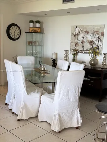 a living room with furniture and wall paintings