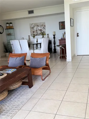 a living room with furniture and a dining table