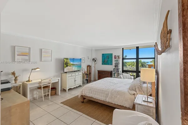 a living room with furniture a flat screen tv and next to a window