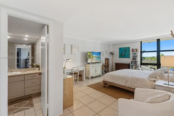 a bedroom with a bed and a view of living room
