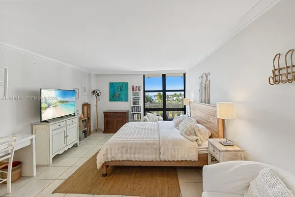 a bedroom with a bed and a flat screen tv