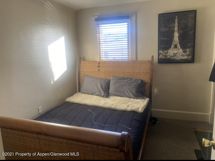 706 Railroad Avenue Rifle, CO 81650 - Photo 5 of 11 a bed sitting in a bedroom next to a window