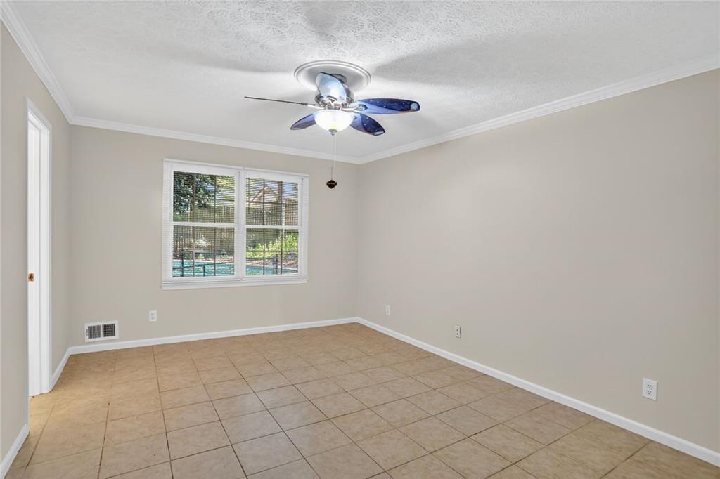 2817 Thornridge Drive Atlanta, GA 30340 - Photo 12 of 15 an empty room with windows and fan