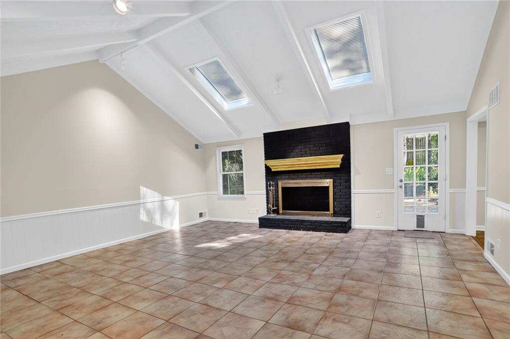 2817 Thornridge Drive Atlanta, GA 30340 - Photo 2 of 15 a view of an empty room with a fireplace and a window
