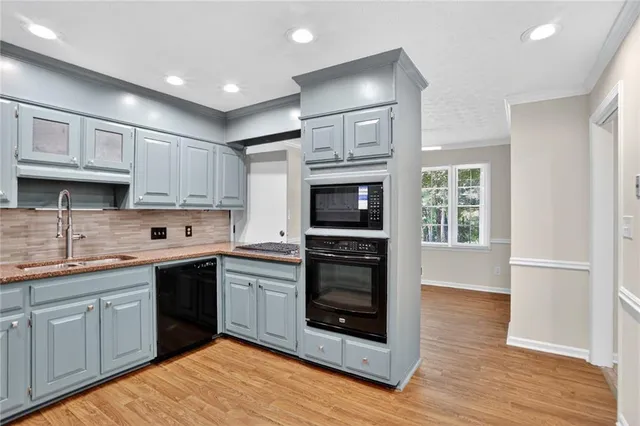 a kitchen with stainless steel appliances granite countertop a stove sink and cabinets