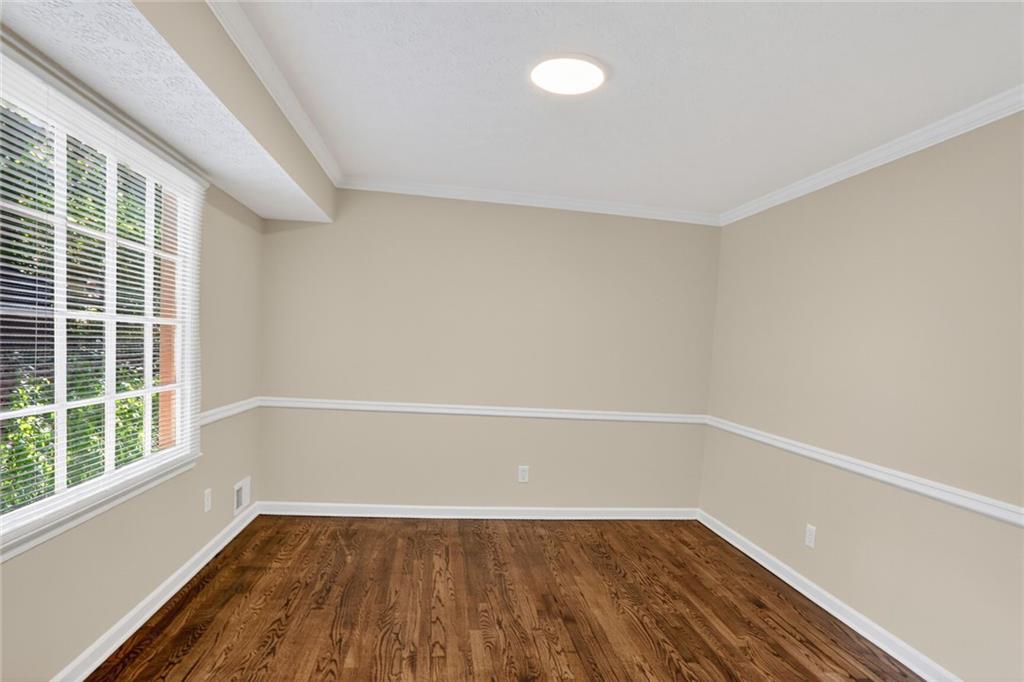 2817 Thornridge Drive Atlanta, GA 30340 - Photo 9 of 15 a view of an empty room with wooden floor and a window