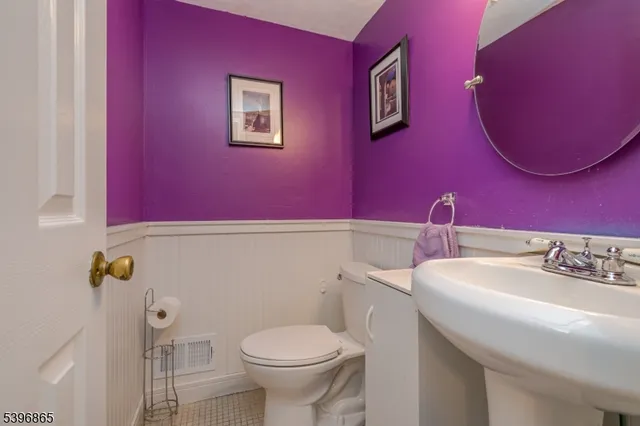 a bathroom with a sink and mirror with toilet