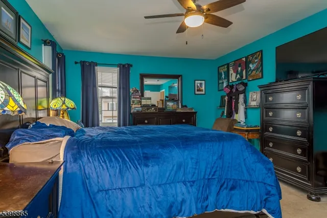 a bed room with furniture and a flat screen tv