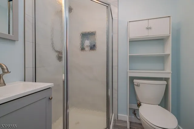 a bathroom with a toilet a sink and shower
