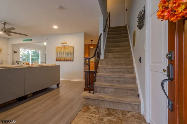 a view of entryway and hall with wooden floor