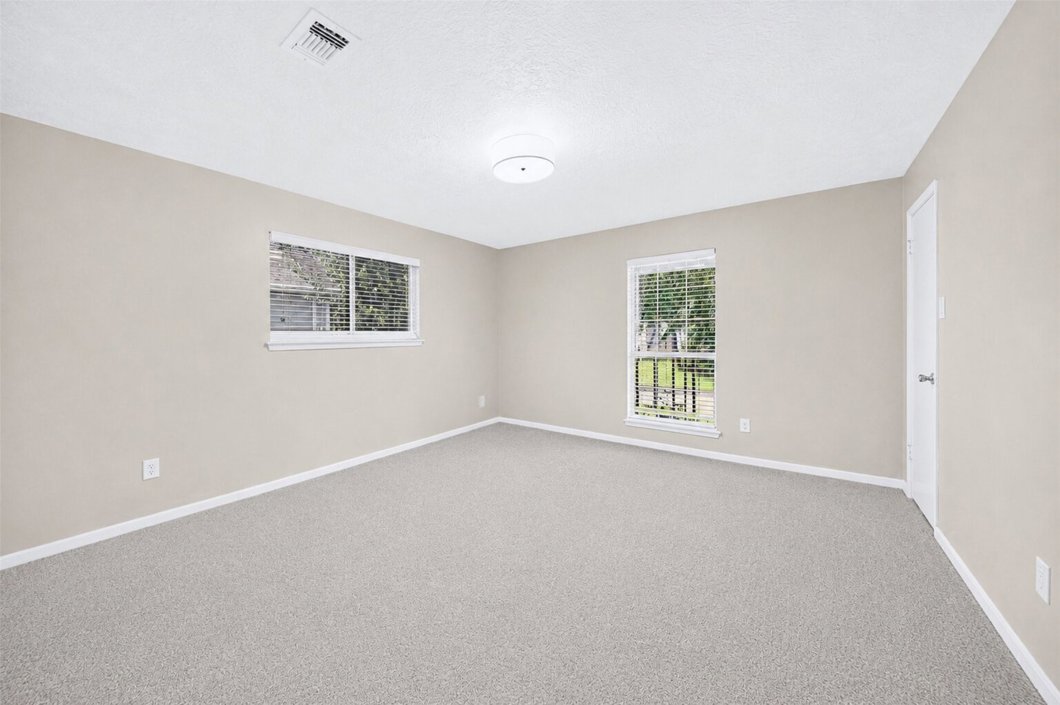 6507 Spring Leaf Drive Spring, TX 77379 - Photo 27 of 50 Spacious third bedroom featuring a neutral color palette, new plush carpeting, and large windows to fill the room with natural light.
