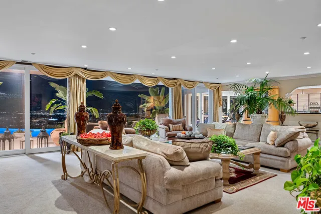 a living room with furniture and flowers
