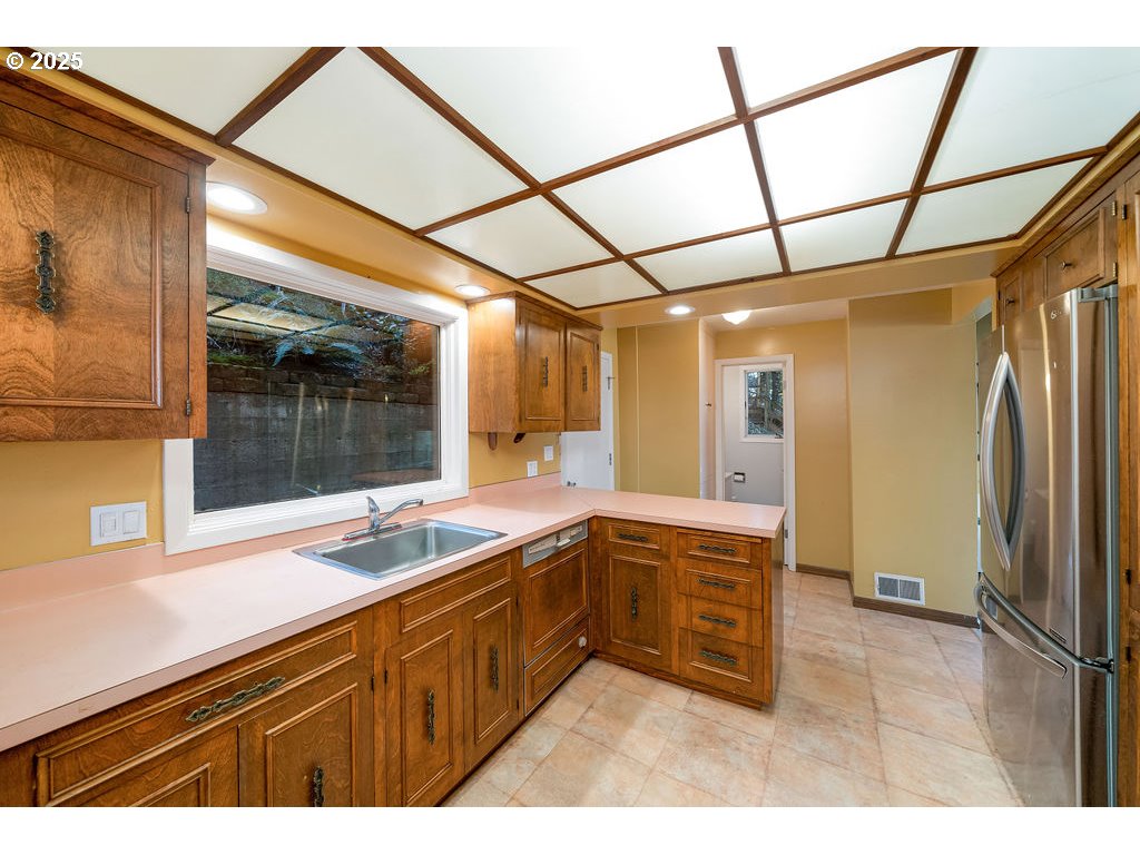 2604 Southwest Buckingham Avenue Portland, OR 97201 - Photo 20 of 32 a kitchen with a sink and refrigerator