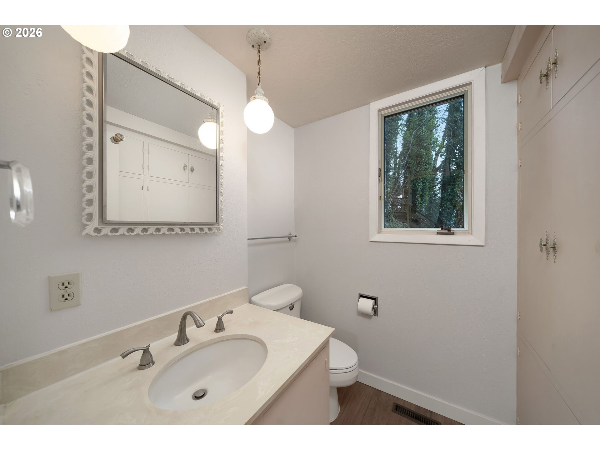 2604 Southwest Buckingham Avenue Portland, OR 97201 - Photo 24 of 32 a bathroom with a sink and a mirror