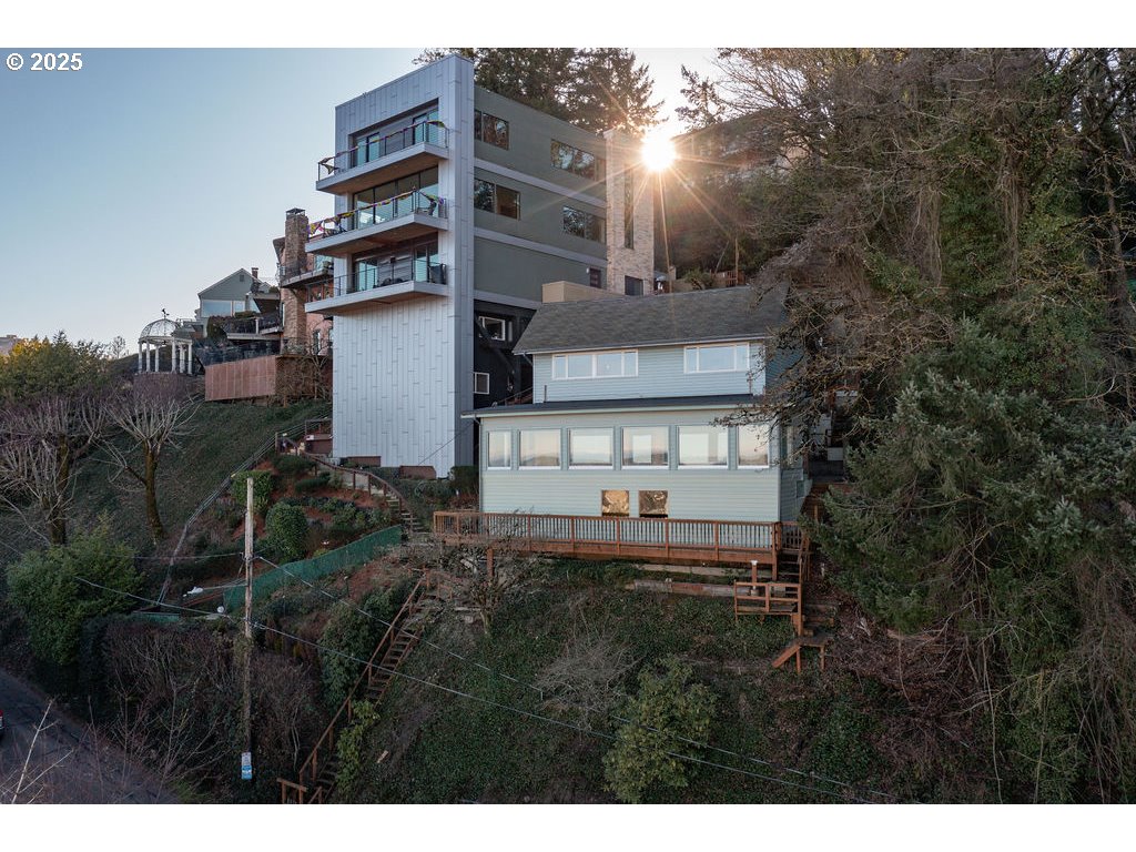 2604 Southwest Buckingham Avenue Portland, OR 97201 - Photo 3 of 32 a view of a house with a backyard and trees