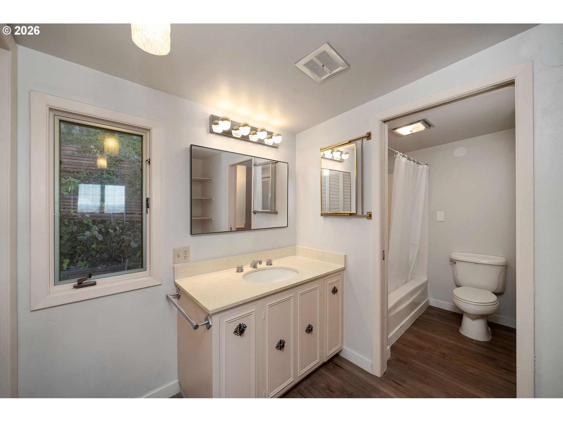 2604 Southwest Buckingham Avenue Portland, OR 97201 - Photo 8 of 32 a bathroom with a sink a toilet and shower