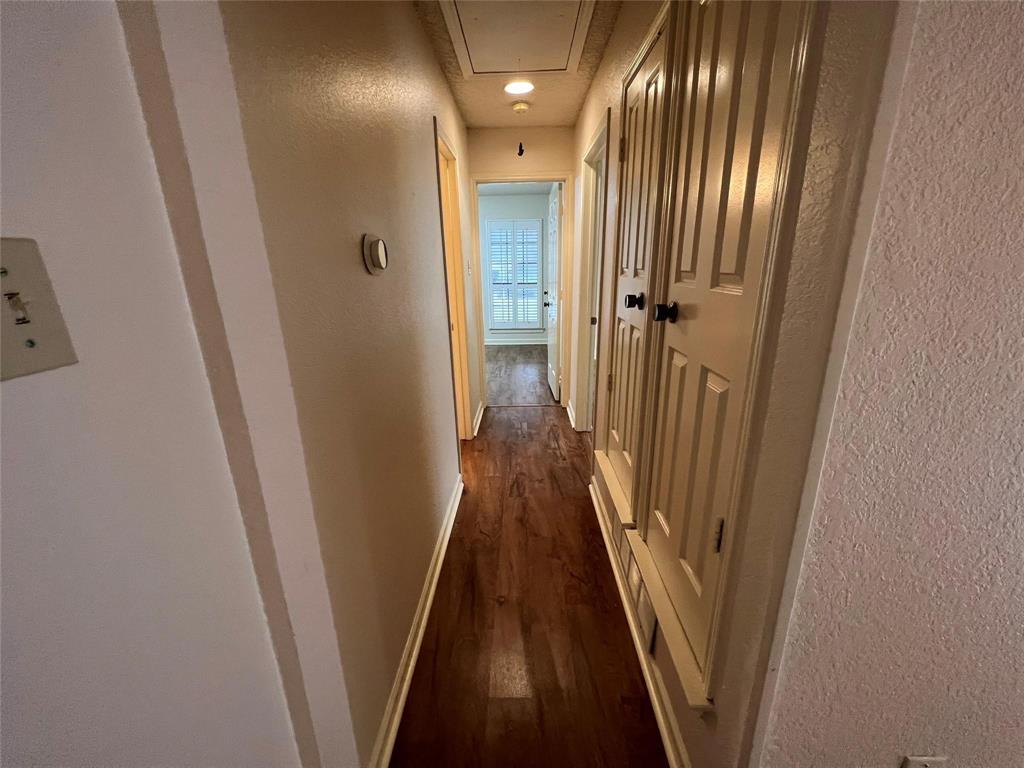 3129 Sappington Place Fort Worth, TX 76116 - Photo 13 of 15 Hall featuring a textured wall, attic access, and dark wood-style floors