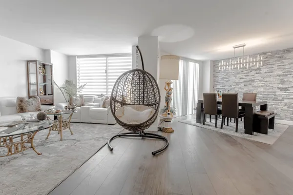 a view of a livingroom with furniture window and wooden floor