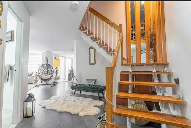 a view of a livingroom with furniture staircase and a living room