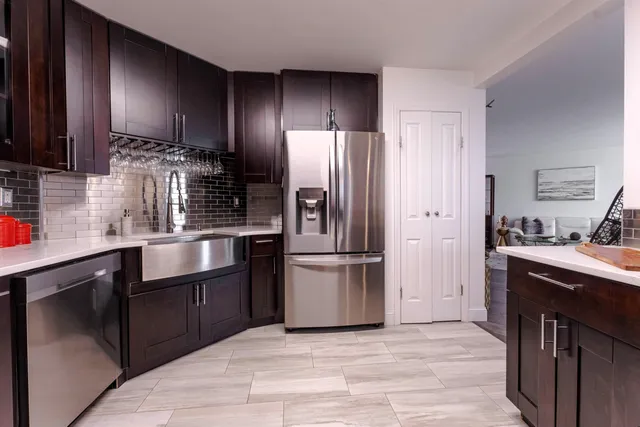 a kitchen with kitchen island granite countertop wooden cabinets and stainless steel appliances