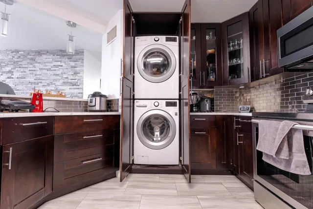 a utility room with sink dryer and washer