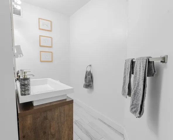 a bathroom with a sink and mirror