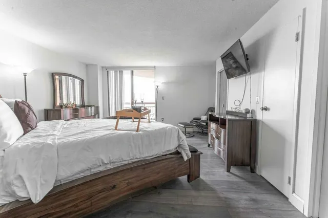 a bed room with a bed and a tv