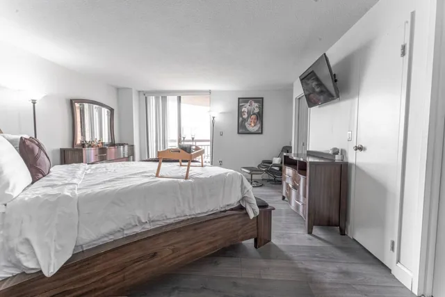 a bed room with a bed and a television