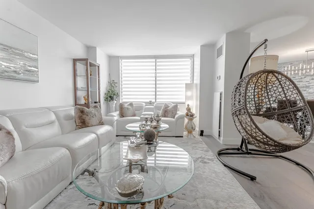 a living room with furniture a piano and a window