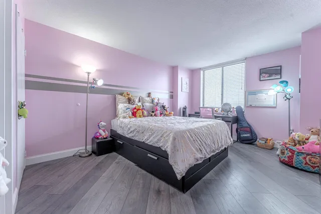 a spacious bedroom with a bed and a window