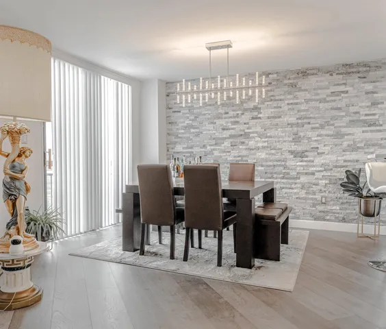 a view of a dining room with furniture and chandelier