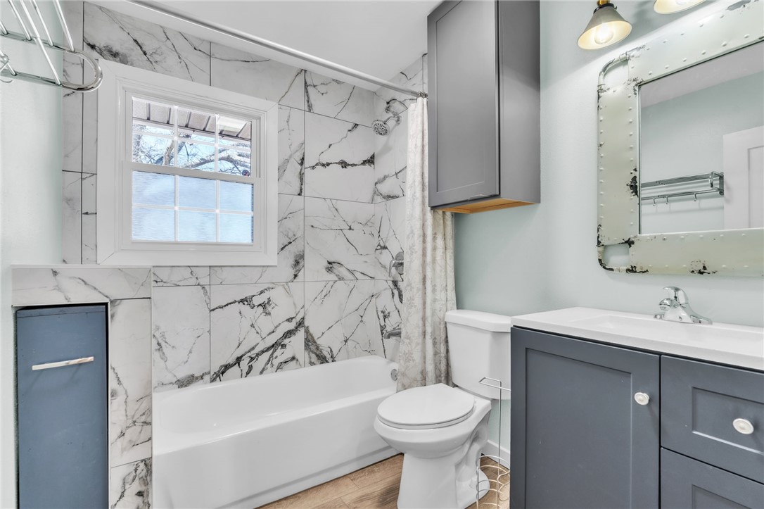 2038 Avant Circle Anderson, SC 29625 - Photo 19 of 32 Bright and inviting bathroom featuring a tiled tub, sleek vanity, and a window for natural light.