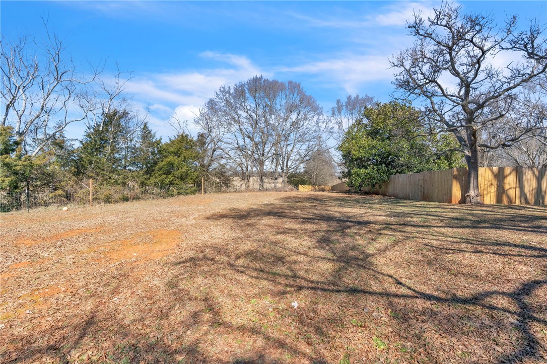 2038 Avant Circle Anderson, SC 29625 - Photo 24 of 32 This spacious yard features a wooden fence, offering privacy and a verdant backdrop for outdoor activities.
