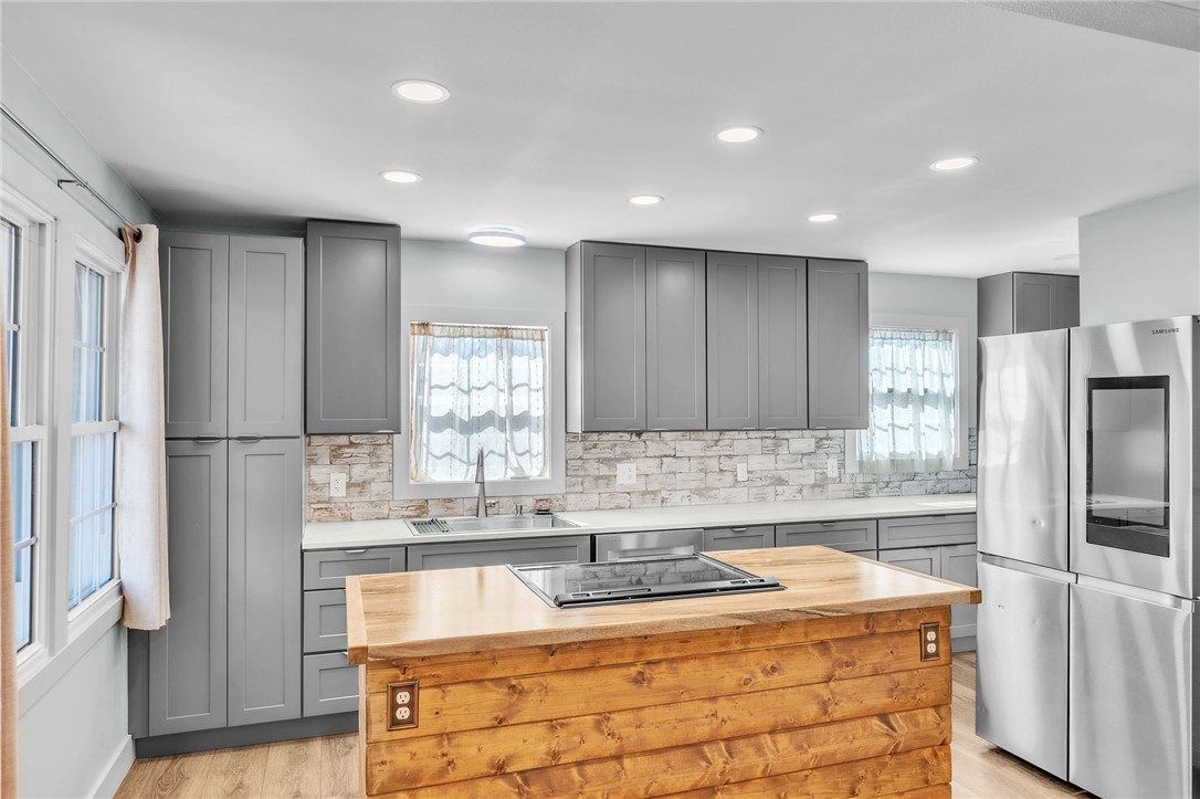 2038 Avant Circle Anderson, SC 29625 - Photo 10 of 32 This modern kitchen features sleek cabinetry, a spacious island, and bright recessed lighting.