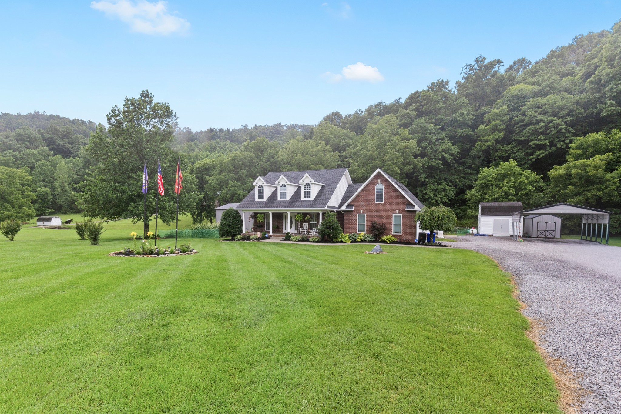 454 Campbell Hollow Road Bethpage, TN 37022 - Photo 4 of 57 a view of a big house with a big yard and large trees