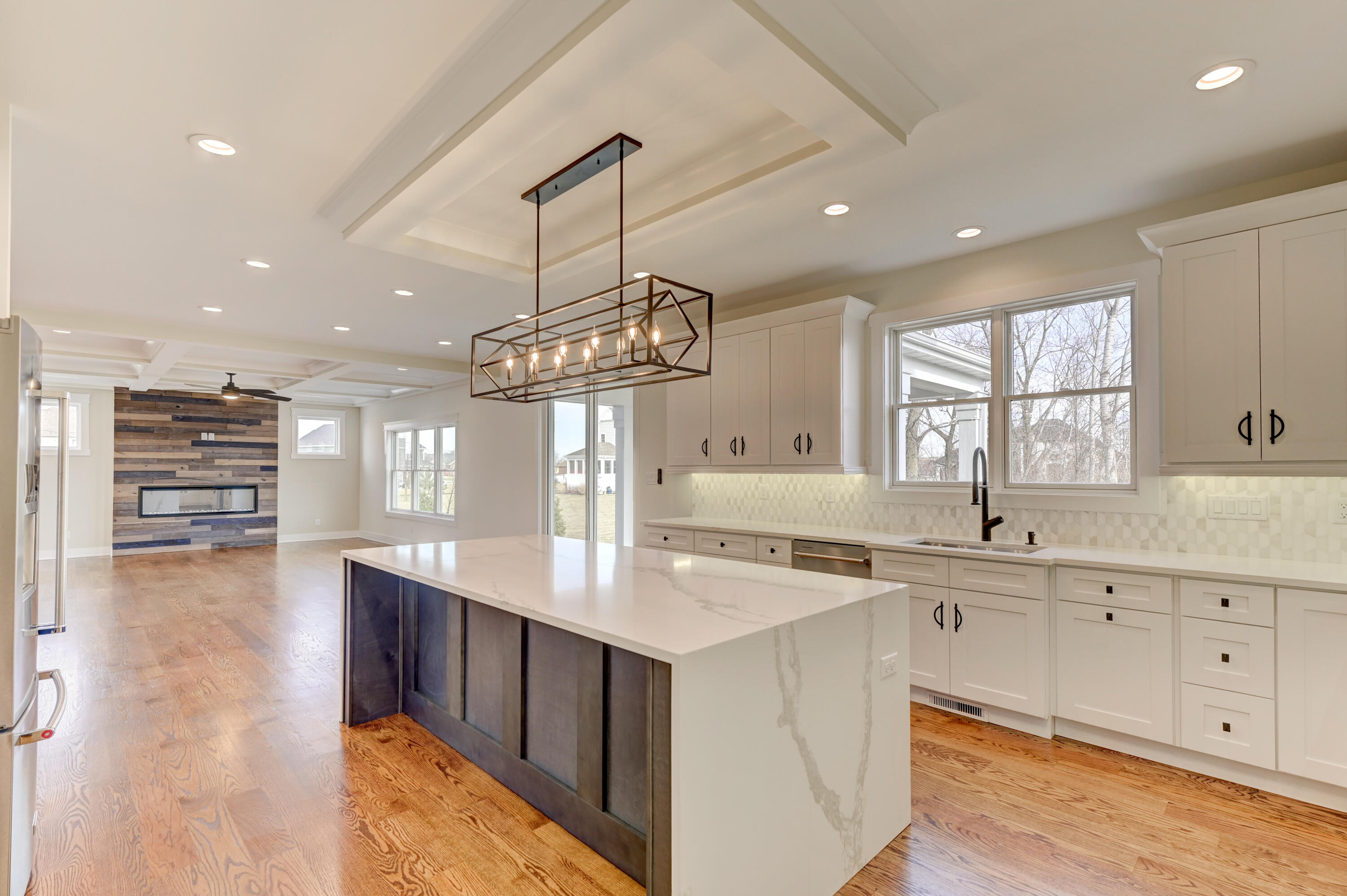10155 Barbara Lane Munster, IN 46321 - Photo 11 of 36 a kitchen with kitchen island granite countertop a stove a sink a center island and wooden floor