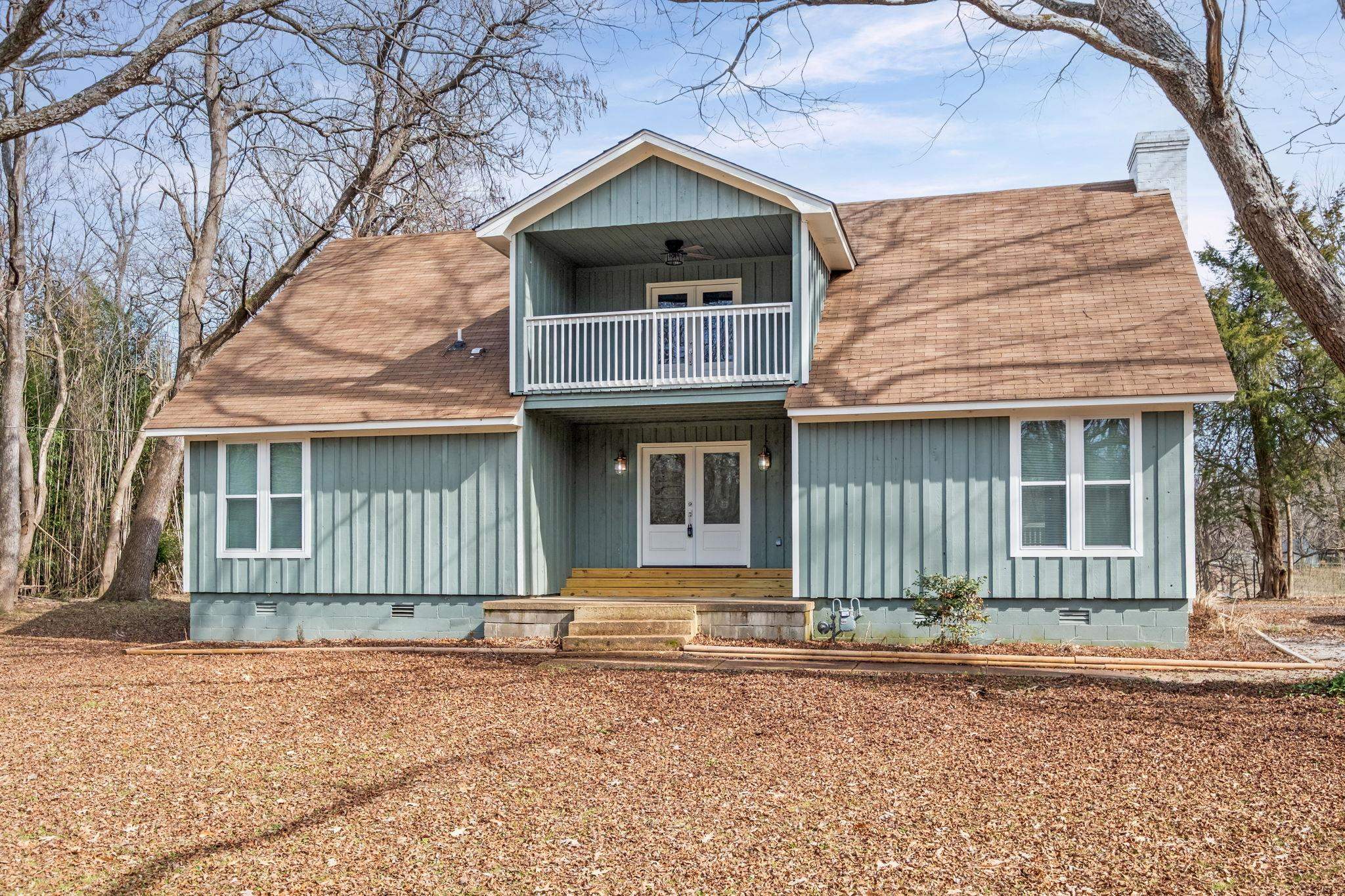 6224 Benjestown Road Memphis, TN 38127 - Photo 1 of 38 View of front of property with crawl space, a shingled roof, a balcony, and a chimney